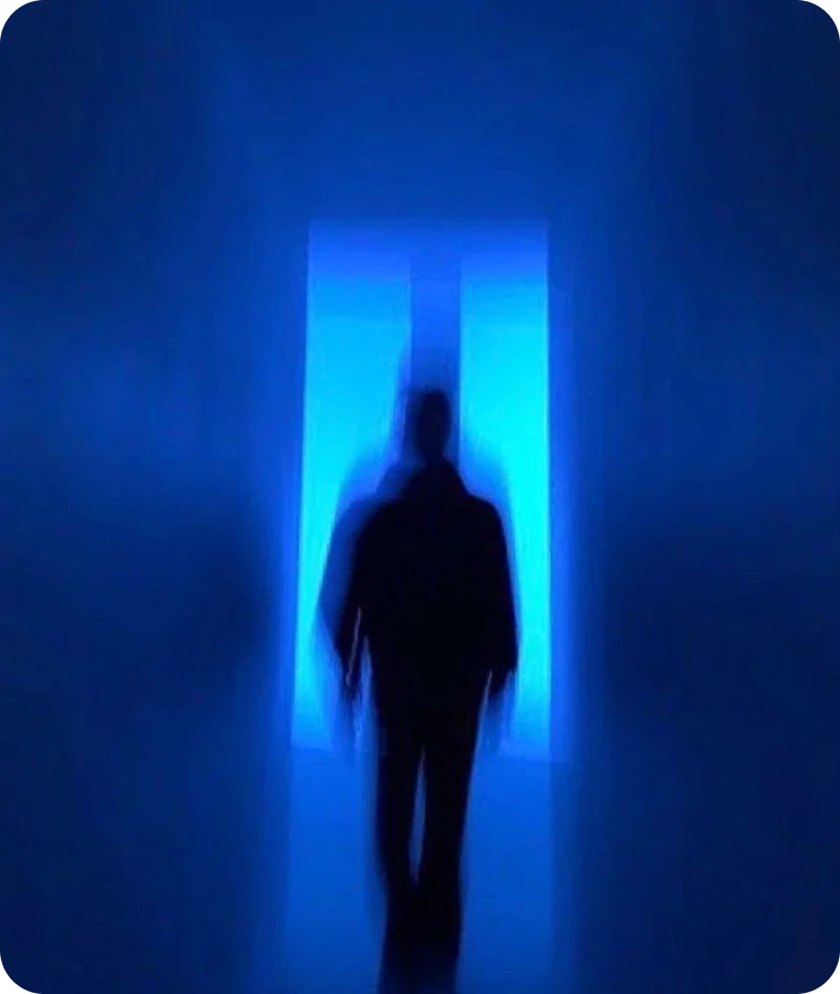 A figure silhouetted in a glowing blue doorway